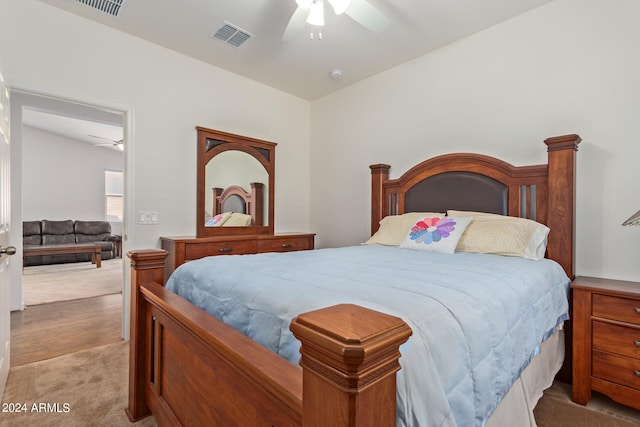 bedroom with ceiling fan and light carpet