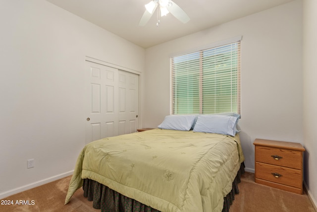 bedroom with carpet flooring, ceiling fan, and a closet