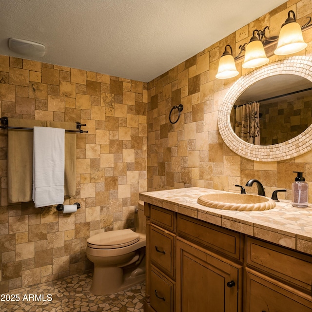 bathroom featuring vanity, a textured ceiling, toilet, and a shower with shower curtain