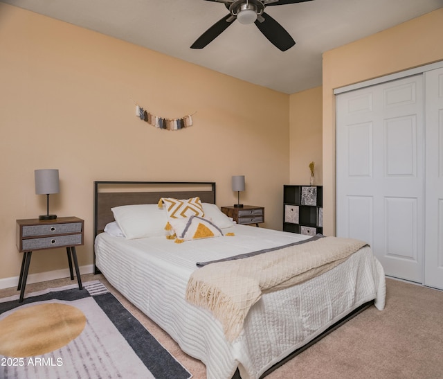 carpeted bedroom with ceiling fan and a closet