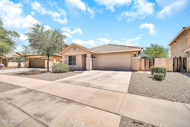 597 S 167th Dr, Goodyear, AZ 85338 - view of front of property with a tile roof, stucco siding, an attached garage, driveway, and a gate