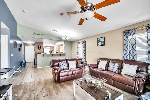597 S 167th Dr, Goodyear, AZ 85338 - living room with ceiling fan, vaulted ceiling, wood finished floors, and a chandelier