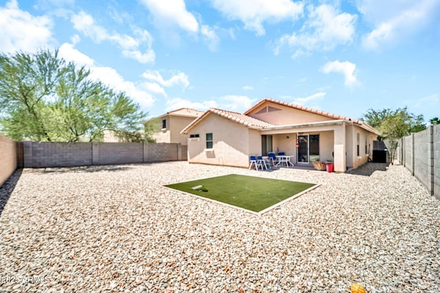 597 S 167th Dr, Goodyear, AZ 85338 - back of property featuring stucco siding, a patio, a tile roof, and a fenced backyard