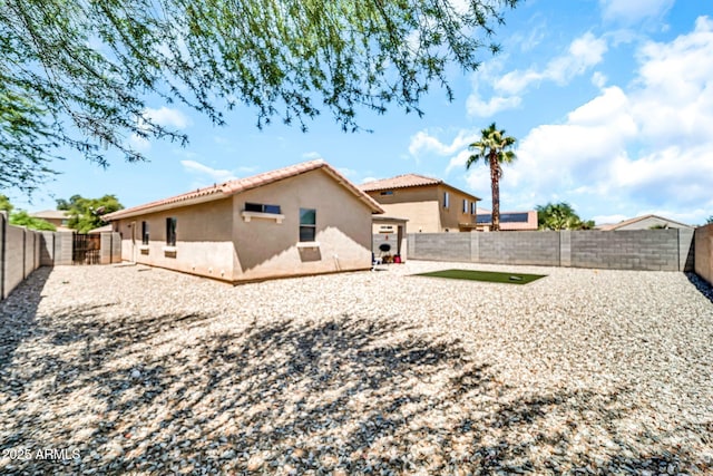 597 S 167th Dr, Goodyear, AZ 85338 - back of house featuring stucco siding, a tiled roof, and a fenced backyard