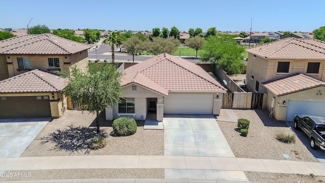 597 S 167th Dr, Goodyear, AZ 85338 - mediterranean / spanish home with driveway, a residential view, a tiled roof, an attached garage, and stucco siding