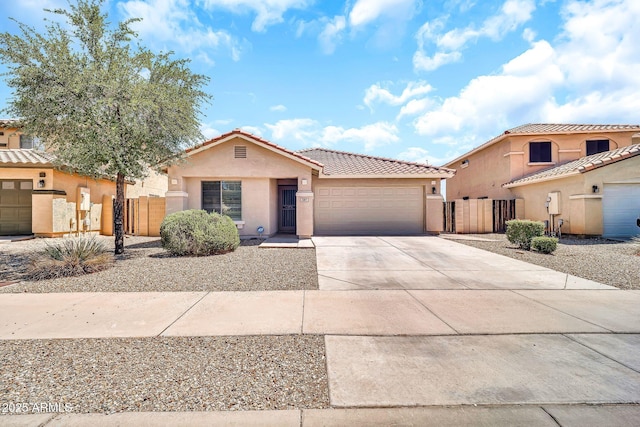 597 S 167th Dr, Goodyear, AZ 85338 - view of front facade featuring a tiled roof, stucco siding, concrete driveway, a garage, and a gate