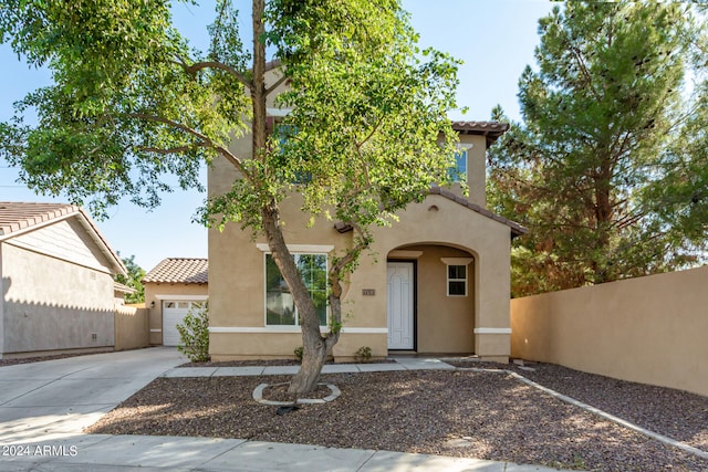 mediterranean / spanish-style home with a garage