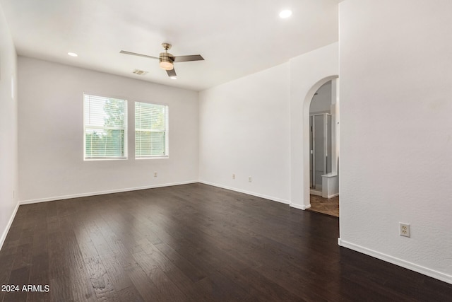 spare room with ceiling fan and dark hardwood / wood-style floors