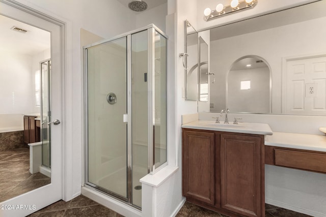 bathroom featuring vanity, tile patterned floors, and walk in shower