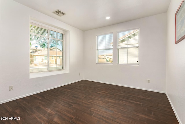 spare room with dark hardwood / wood-style flooring