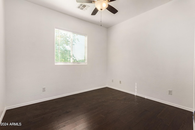 unfurnished room featuring dark hardwood / wood-style floors and ceiling fan