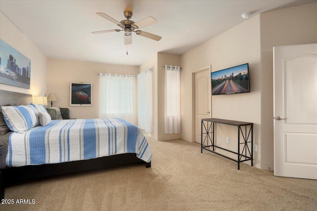 bedroom featuring light carpet and a ceiling fan