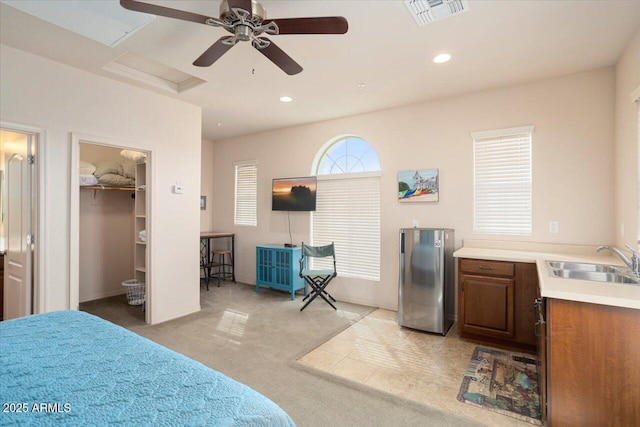 bedroom with recessed lighting, light colored carpet, a sink, visible vents, and freestanding refrigerator