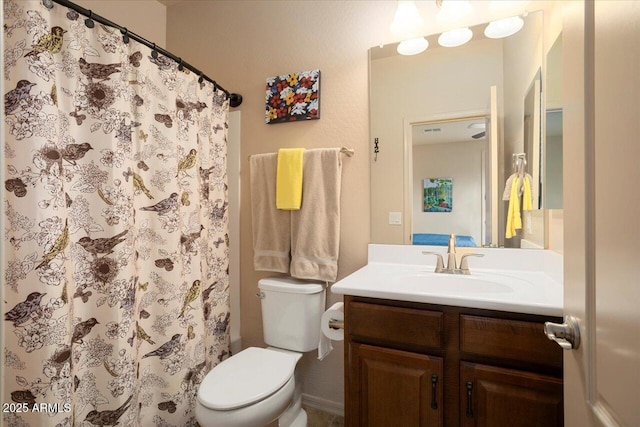 bathroom featuring a shower with shower curtain, vanity, and toilet