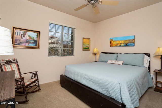 bedroom with light carpet, ceiling fan, and baseboards