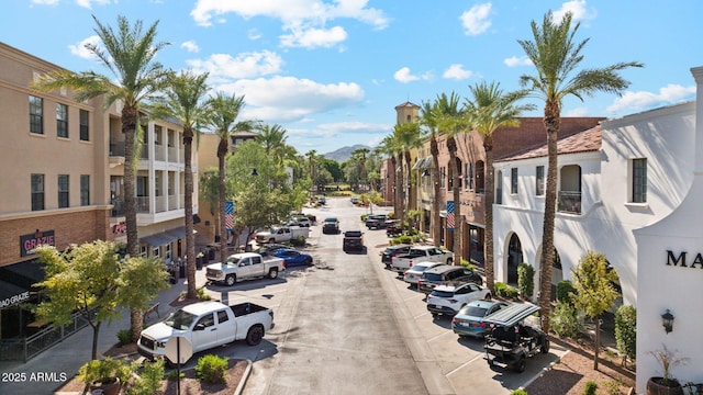 view of street featuring sidewalks, street lighting, and curbs