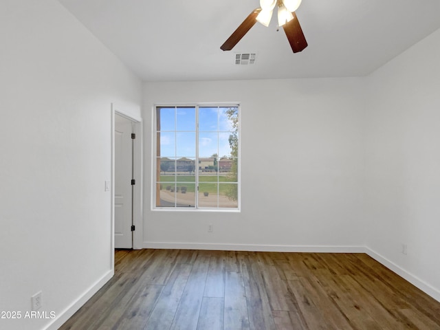 empty room with hardwood / wood-style flooring and ceiling fan