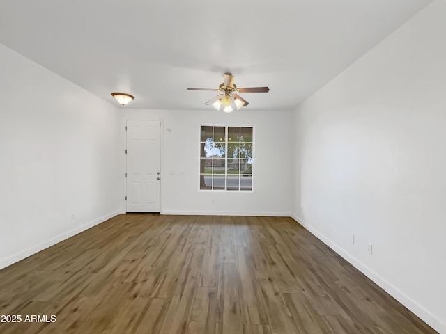 unfurnished room with ceiling fan and dark hardwood / wood-style floors