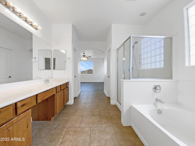 bathroom with ceiling fan, vanity, shower with separate bathtub, and tile patterned flooring