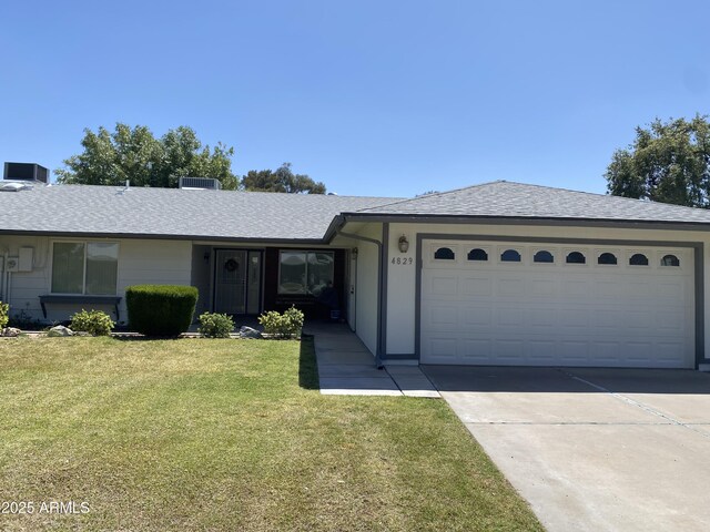 single story home with a garage and a front yard