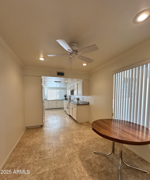 kitchen with ceiling fan and ornamental molding