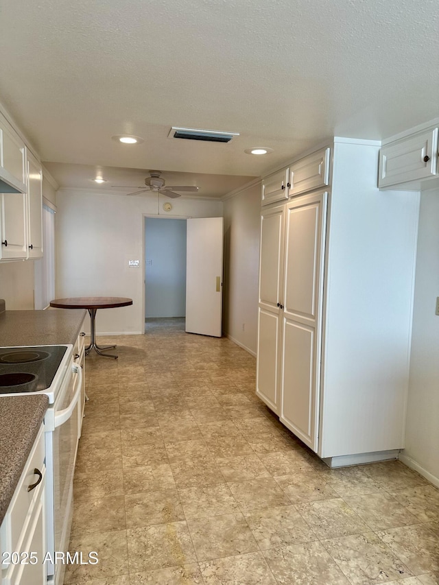 kitchen featuring ceiling fan, a textured ceiling, white cabinets, and white electric range oven