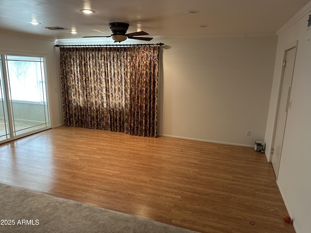 spare room with wood-type flooring, ornamental molding, and ceiling fan