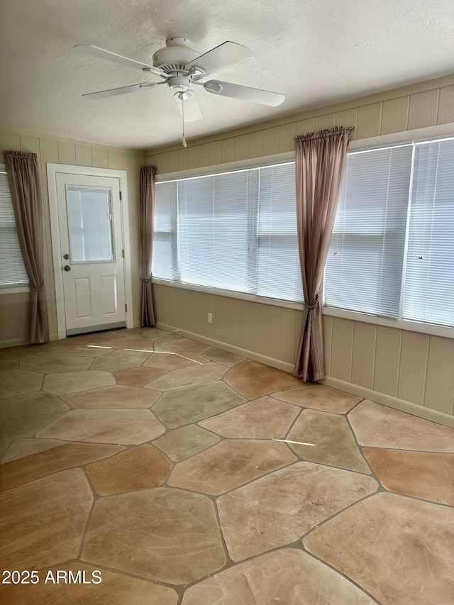 interior space featuring a textured ceiling and ceiling fan