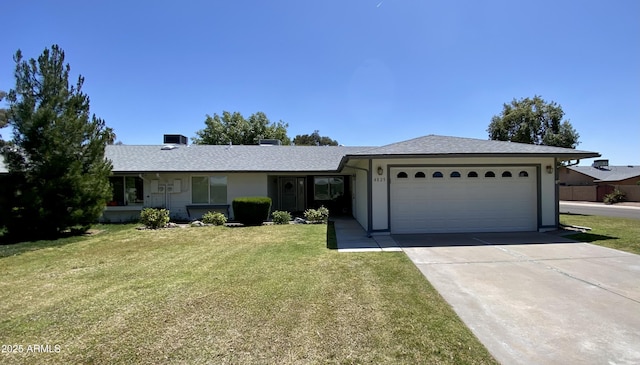 single story home featuring a garage and a front lawn