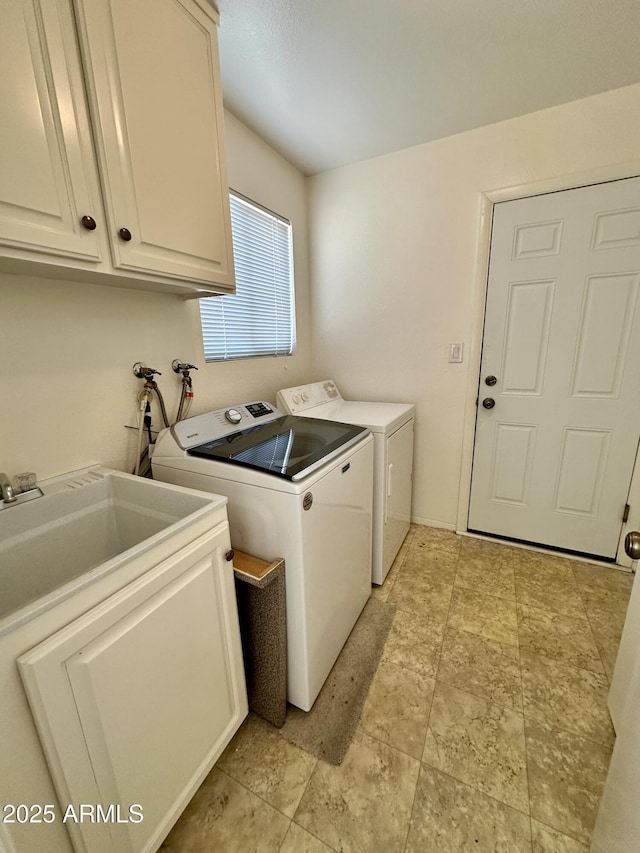 washroom with cabinets and washer and clothes dryer