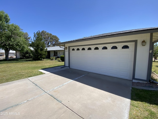 garage featuring a lawn