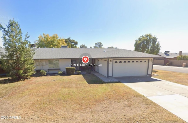 single story home featuring a garage and a front lawn