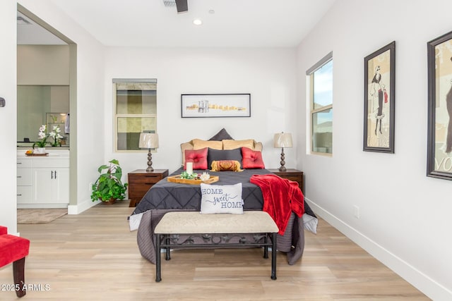 bedroom with light wood finished floors, baseboards, connected bathroom, and recessed lighting