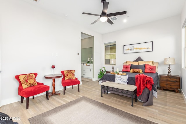 bedroom featuring visible vents, ceiling fan, connected bathroom, wood finished floors, and baseboards