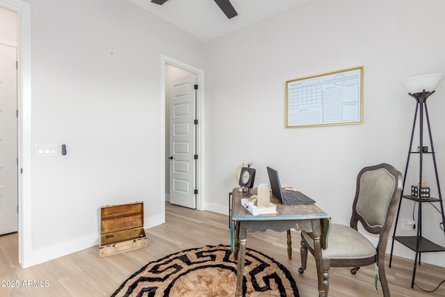 office area featuring light wood-type flooring, ceiling fan, and baseboards