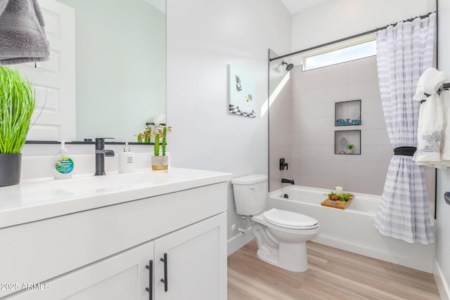 full bathroom with toilet, wood finished floors, vanity, baseboards, and washtub / shower combination