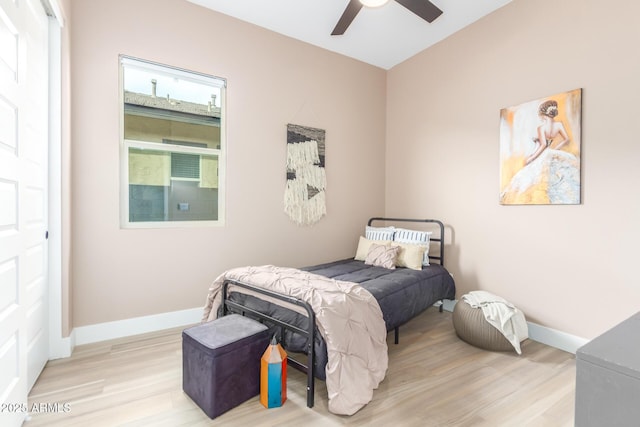 bedroom featuring ceiling fan, wood finished floors, and baseboards