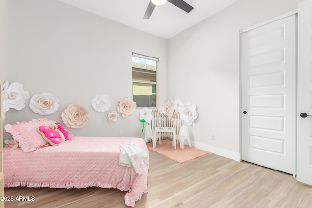 bedroom with wood finished floors, a ceiling fan, and baseboards