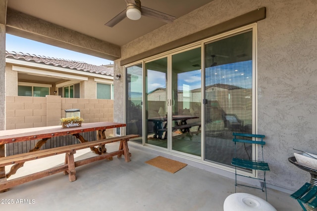 view of patio / terrace with fence and a ceiling fan