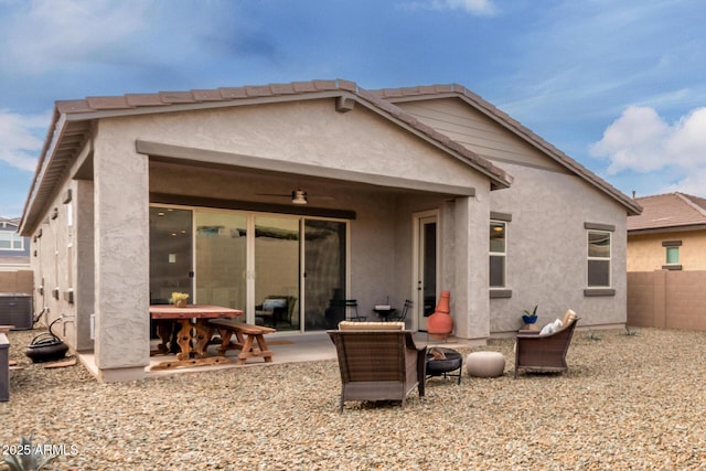 rear view of house featuring a patio, central AC, a tile roof, fence, and stucco siding