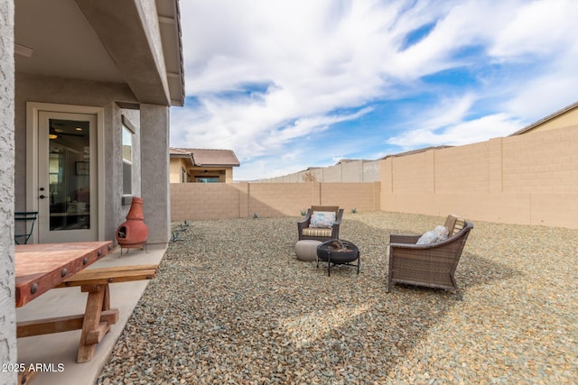 view of yard with an outdoor fire pit and a fenced backyard