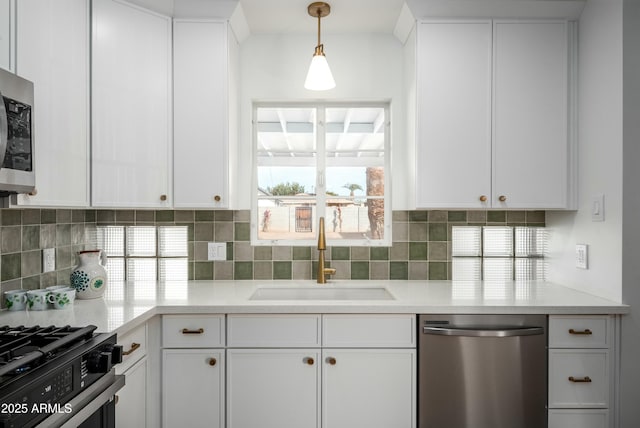 kitchen with stainless steel appliances, white cabinetry, and sink