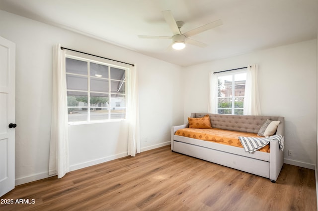 sitting room with wood-type flooring and ceiling fan