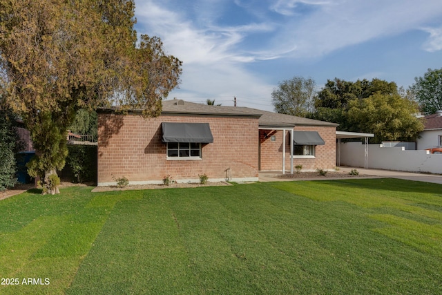 rear view of property with a lawn