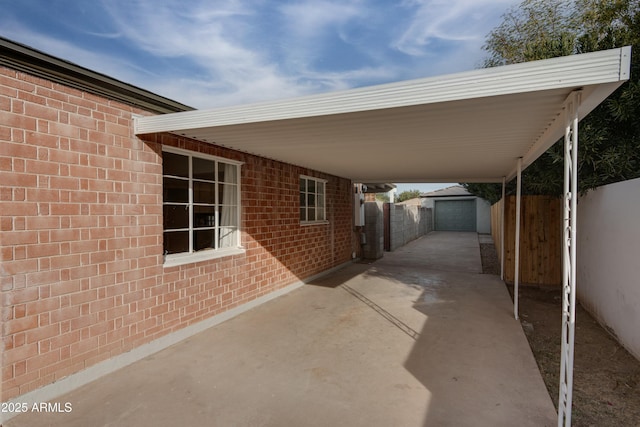 view of patio with a garage and an outdoor structure