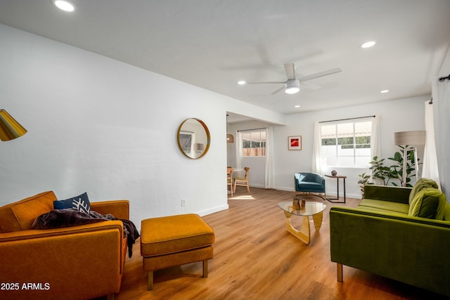 living room with hardwood / wood-style floors and ceiling fan