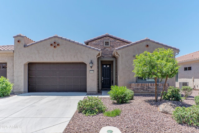 16417 W Piccadilly Rd, Goodyear, AZ 85395 - mediterranean / spanish-style home with a garage, stucco siding, driveway, and a tile roof