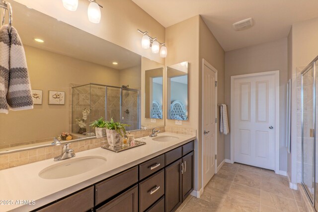 16417 W Piccadilly Rd, Goodyear, AZ 85395 - full bath with a shower stall, double vanity, and tile patterned floors
