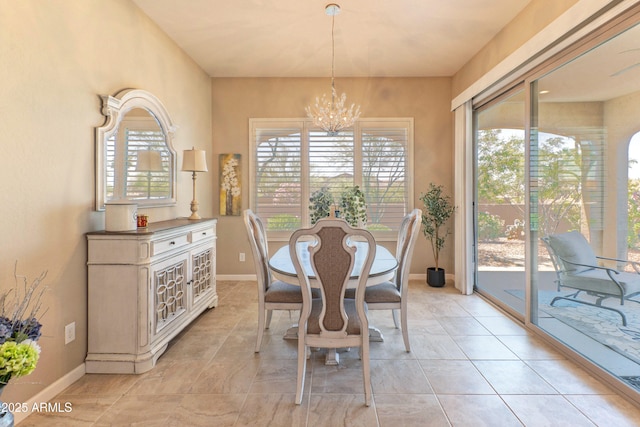 16417 W Piccadilly Rd, Goodyear, AZ 85395 - dining room featuring plenty of natural light, a chandelier, baseboards, and light tile patterned flooring