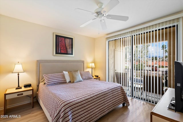 bedroom with ceiling fan, wood-type flooring, and access to exterior